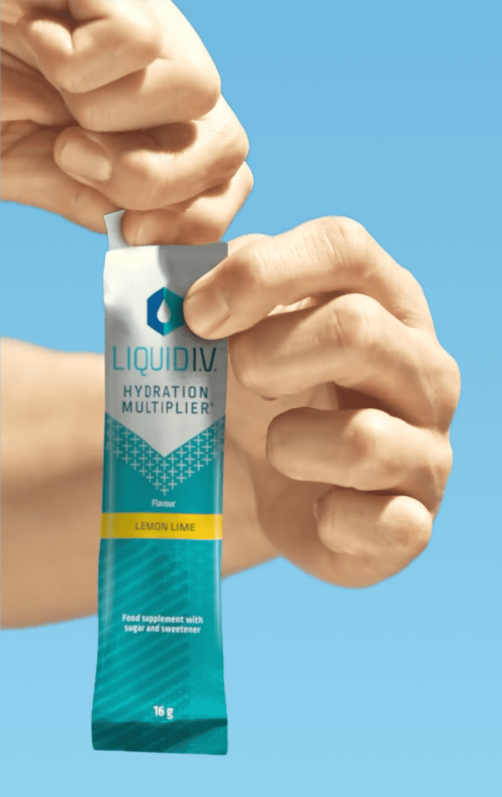 Hands tearing open a Liquid I.V. Hydration Multiplier Lemon-Lime stick.